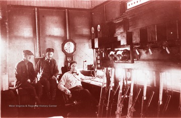 Harry Simpson is seated at the desk with the telegraph transmitter and two unidentified men are sitting behind him. The telegraph office was located at the Chesapeake and  Ohio Depot in Prince, Fayette County, West Virginia.