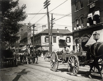 Horses, wagons, and pedestrians on High Streeet.<br />