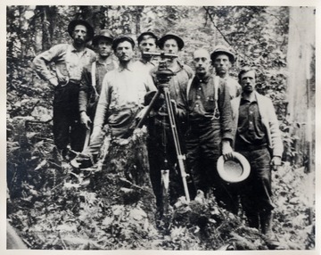 Portrait of crew with surveying equipment.