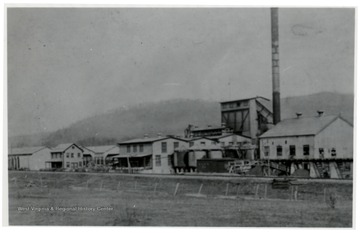 Extract plant with large smoke stack.  