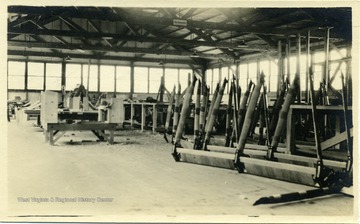 World War I era airplane landing gear lined up in a hangar.