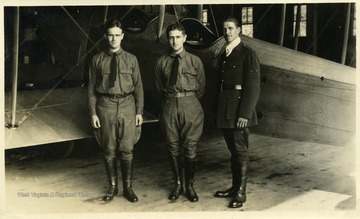 Officers of the West Virginia Flying Corps, including (left to right) Lieutenant Thomas Kent, Captain Louis Bennett, Jr., and Lieutenant William Frey.  They are standing in front of a Curtiss JN or "Jenny" aircraft.  This photograph appeared with an article regarding the W. Va. Flying Corps in the July 29, 1917 issue of the Wheeling Sunday News on page eight of part iii.