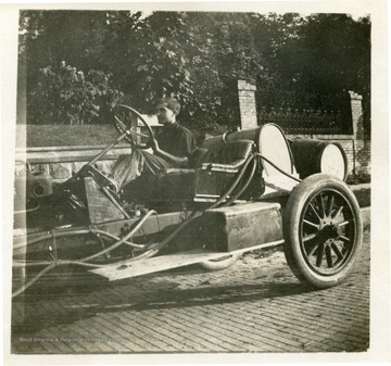 Louis Bennett, Jr. driving his car at approximately age 12.  See 'Cross and Cockade Journal' vol. 21, no. 4, winter 80 (West Virginia Collection Pamphlet no. 14277) for an identification on candid portrait of Bennett in car.