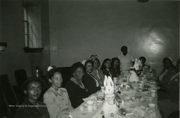 Picture of the Y.M.W. luncheon which took place at the Memorial Building in Kimball, McDowell County, Monday, March 27th, 1950 at 1 o'clock. The luncheon was free and the purpose of the meeting was to discuss plans for organizing Older Youth Groups. The age limits for YMW club membership was approximately 18 to 30. Married and unmarried young people are eligible. In every community there was a need for a program to bridge the gap between organized junior programs and the homemakers program and to include both men and women. 
