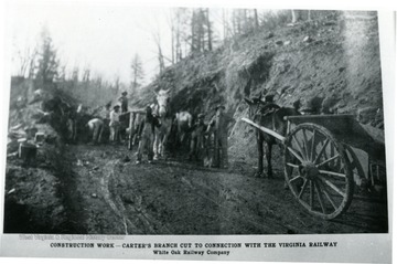 Men and horses stand in cut in hillside.  This construction work done by the White Oak Railway Co. was the Carter's Branch Cut to connection with the Virginia Railway.