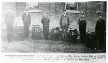 Group portrait of miners and rescue equipment.  This group took first place at competitions St. Louis.  From Left to Right: Frank Colline, Edward Graff, Howard Samuels, Andrew Lightfoot, R.P. Nicholls and Fred Lamb.