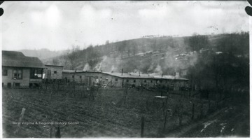 View of barracks with smoke coming from the chimneys.