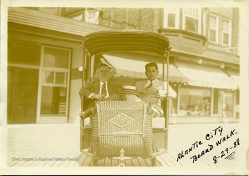 Joe Ozanic (on right) and another man sitting in a cart at the Atlantic City Boardwalk. Joseph Ozanic was a Progressive Mine Workers of America Activist and Officer.