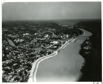 'Charleston, W. Va-Capitol in distance-at junction of Elk River with Kanawha. Boulevard occupies in great part originial section of James River and Kanawha Turnpike. Here old stage coaches ferried across the river.'