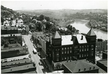 View of Fairmont next to the river. 'Before Watson Hotel was torn down on the corner of Main and Madison St.'