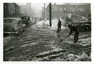 Two men are shoveling snow in Fairmont, West Virginia after the big snow storm of 1950.