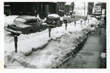 Cars are parked along Monroe Street in Fairmont, West Virginia during the big snow storm of 1950.