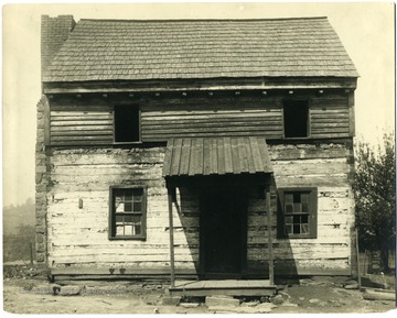 Two story log cabin with covered entrance, the first house in Grafton, W. Va., built in 1811.  The first child born in Grafton was born here in 1847.