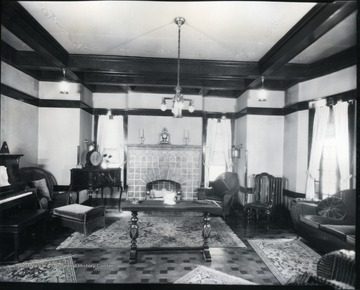 Interior view of the Bartlett living room with fireplace, piano and furniture.