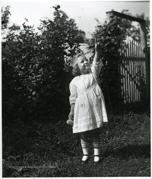 Child, Grace Holtkamp (Herrstrom), pointing toward the sky.  Helvetia, W. Va.
