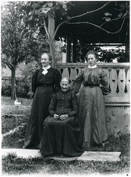 Mrs. Aegerter standing on the left with Elizabeth Berger Dubach, seated in the center, who is mother of Elise Dubach Berky (Burki), standing on the right.