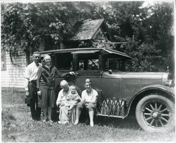 Holtkamp and Aegerter Family members in front of a car, Helvetia, W. Va.