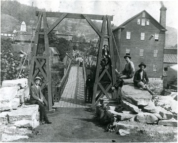 'Footbridge across the West Fork of the Monongahela River, Weston, W. Va., directly in front of the main entrance to the Weston State Hospital, ca. 1895.'