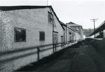 'View looking north along Rail road shows additions and original mill portions of east side of building.' 
