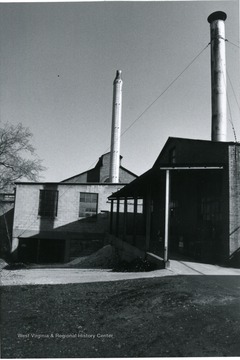 'View from river side looking north at end of factory showing additions.'