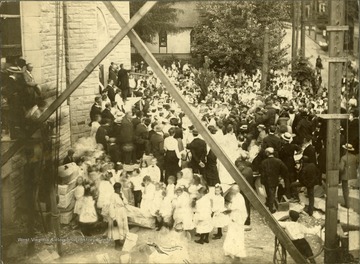 Large crowd gathered for a church dedication (probably Wesley Methodist, corner of High Street and Willey Streets), Morgantown, W. Va.