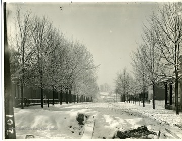 'South view of High Street near the Post Office and Montgomery Ward Store.' A view of High Street on a snowy winter day before 1926, because the High Street Bridge wasn't built yet. 