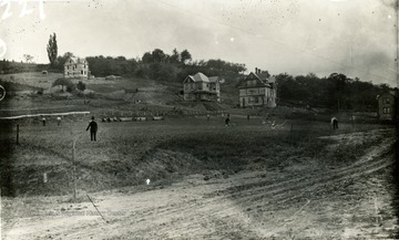 Construction of houses on fraternity row can be seen along dirt road which is High Street in Morgantown, W. Va. 