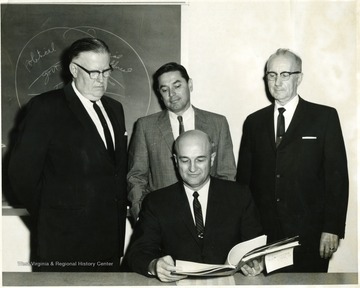 'Back Row from left to right: Charles Stevenson, Superintendent of Schools, James McCartney, President of the Chamber of Commerce, Elmer Prince, City Manager.  Sitting: Ernest J. Nesius, Head of Appalachian Center.'