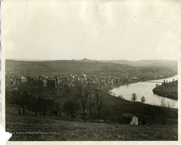 'University and Morgantown (about 1891-92. No Science Hall then; Clock on Martin Hall; Walnut Street had a dead end with the Firehouse seen beyond Martin Hall; Monongalia Academy at the site of the Junior High School; site of Grand Street in  the distance beyond the Academy; Suspension Bridge across the river. 6-1/2 x 8-1/2 inch negative by John L. Johnston, enlargement by Molby (1938).'