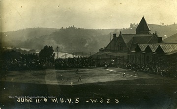 WVU playing a baseball game against Washington and Jefferson College behind Stewart Hall.  The Monongahela River is visible in the distance.  WVU won the game 5-3.