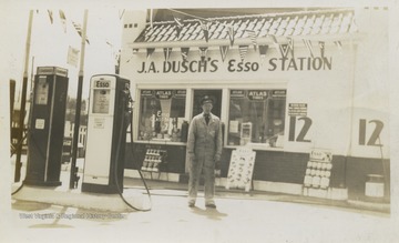 Joseph A. Dusch's Esso Service Station in Wheeling, W. Va., on corner of 33rd Eoff streets.  Includes two gas pumps and presumably J.A. Dusch standing in front of his station.