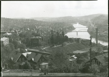 Stadium and Woodburn Hall are in the foreground and the River Bridge over the Monongahela River is in the background.