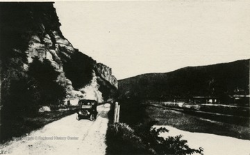 View looking down Harpers Ferry Road in Maryland, along the canal and the Potomac River. Harpers Ferry and Loudon Heights are seen in the background.