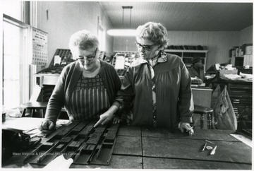'Making up - Stella McLaughlin and Maxine Dever prepare hand set type for the Marlinton, W. Va. weekly newspaper, The Pocahontas Times.'