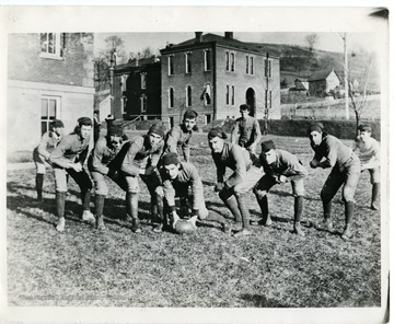 Group portrait of the first intercollegiate football team of West Virginia University. Members include: 'fullback-Dr. Gory Hogg, quarterback-Bivens, line-Smith, Kunst, Price, Blake, Ford, Hughes, Jenkins, Holbert, and Boyd. The first football team to represent West Virginia. It played W & J in 1891. Score W & J (Washington and Jefferson-72, W.V.U.-0. Presented by James M. Orr-1827.'