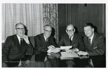 Group portrait of members of the West Virginia University Board of Governors. From left to right: Mr. Lloyd M. Jones; Mr. Walter Linton (Halseny, Stewart, Co.); Mr. Albery B.C. Broy, member, Board of Governors; and Dr. Harry B. Heflin, Acting President of West Virginia University.
