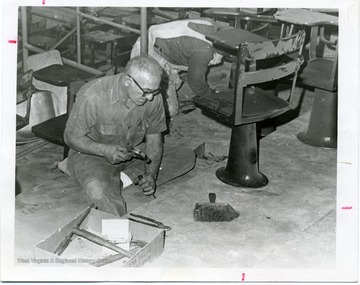 Two workmen reconditioning the Chemistry Building Lecture Room in Clark Hall, West Virginia University.