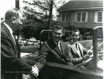 The photograph was taken while West was driven through the streets of Beckley by a very proud fan following West Virginia University's amazing run in the 1959 NCAA Basketball Tournament. The Mountaineers make it to the National Championship game, losing to California by one point. West was named the MVP of the tournament. The others in the photograph are not identified.