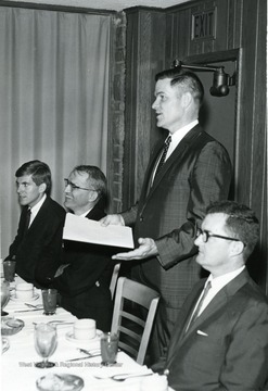 David Hardesty, then student body president sits with (from left to right) David Hess, Paul Selby, Law School Dean, and Jim Watkins at dinner.