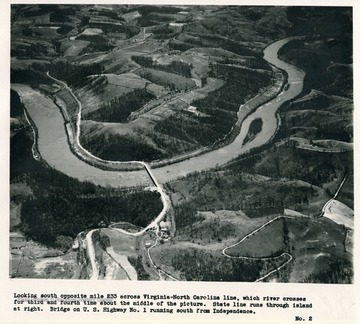 'Looking south opposite mile 233 across Virginia-North Carolina line, which river crosses for third and fourth time about the middle of the picture.  State line runs through island at right.  Bridge on U.S. Highway No. 1 running south from Independence.'