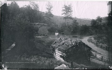 View of log building and fencing at the photographers camp spot. Gen. no. 4, neg. by D, No. 3. Date 1884, July 4. Friday Morning.