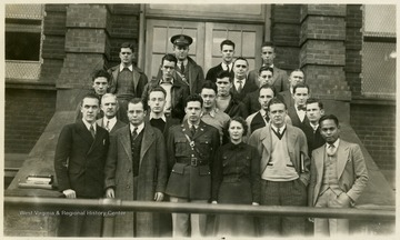 A portrait of an unidentified group on the steps of a building.