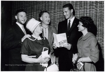 A photograph of Jerry West (second from right) standing with Louise Larkey (right) and Victor Larkey (far left) of Weirton, W. Va., Mrs. O. J. White (front left) of Morgantown, W. Va., and Red Lyons (rear right) of Raleigh County, W. Va.