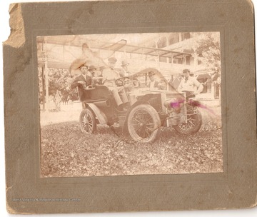 "First car to come to Red Sulphur. The two men standing are J.C. Miller with dark hat on. Bud Dunn with straw hat, Dr. Will Huseter driver of car. Do not know rest. 1906"