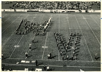 WVU Marching Band performing halftime field show. Forming the WV.