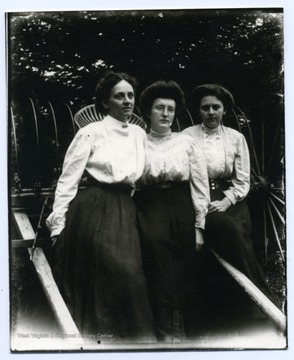 Left to Right: Mini Haslebacher, Olga Aegerter, Lena Haslebacher. Sitting on a horse-drawn hay rake.