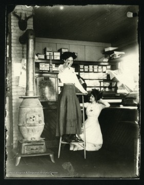 Interior of the Jacob Zumbach store which sat between the Huber Inn and J. Zumbach's house. Ladies unidentified.