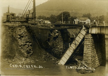 Postcard photograph of a railroad bridge destroyed by the flood waters of Cabin Creek. Information on the back: "Hinton Daily News Collection, John Faulkner Collection; from Jim Pettrey to Stephen Trail, 1997".