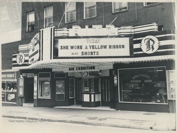 The building, located on Ballengee Street, is advertising "She Wore a Yellow Ribbon" playing that day. 