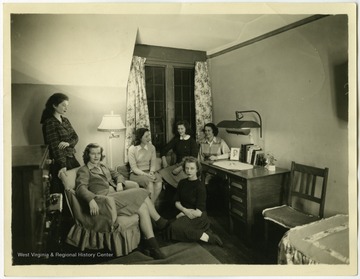 Maryat Lee, seated in a chair on the left, in her friend Bonnie's dorm room at Wellesley College.  Lee graduated from Wellesley in 1945 with a degree in religious studies.  She later studied at Columbia University and Union Theological Seminary in New York City.Maryat Lee (born Mary Attaway Lee; May 26, 1923 – September 18, 1989) was an American playwright and theatre director who made important contributions to post-World War II avant-garde theatre.  She pioneered street theatre in Harlem, and later founded EcoTheater in West Virginia, a community based theater project.Early in her career, Lee wrote and produced plays in New York City, including the street play “DOPE!”  While in New York she also formed the Soul and Latin Theater (SALT), and wrote plays centered around the lives of the actors in the group.In 1970 Lee moved to West Virginia and formed the community theater group EcoTheater in 1975.  Beginning with local teenagers from the Governor’s Summer Youth Program, the rural theater group grew, and produced plays based on oral histories collected from the local community.  Each performance of an EcoTheater play involved audience participation and discussion.  With the assistance of the Humanities Foundation of West Virginia, guest scholars became a part of EcoTheater.